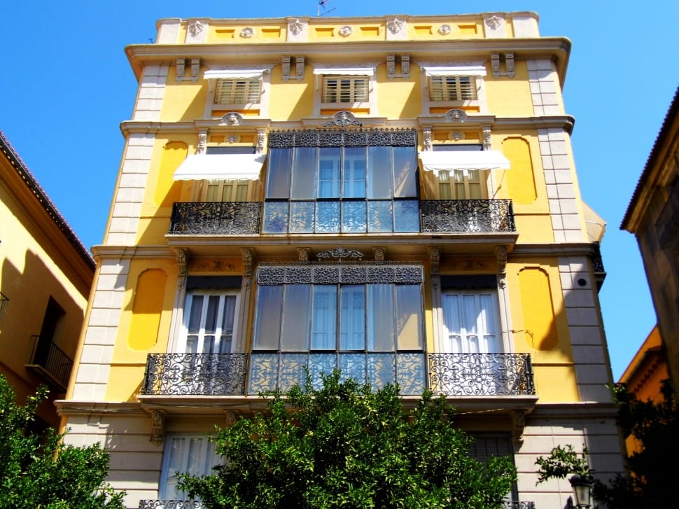 yellow and white 4 storey cement house preview