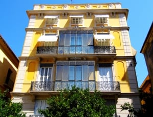yellow and white 4 storey cement house thumbnail