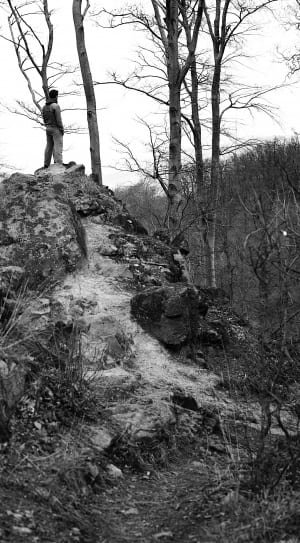 gray scale image of man on hill thumbnail