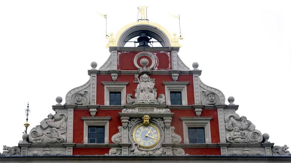 gray and red concrete building with clock preview