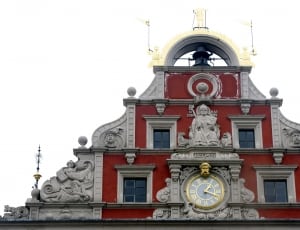 gray and red concrete building with clock thumbnail