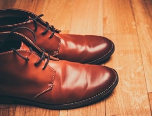 pair of black leather dress shoes on brown surface thumbnail