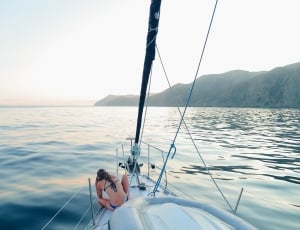 black haired woman in boat during daytime thumbnail