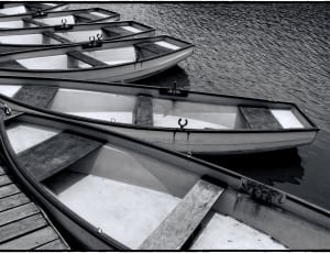 gray scale photo of rowboats thumbnail