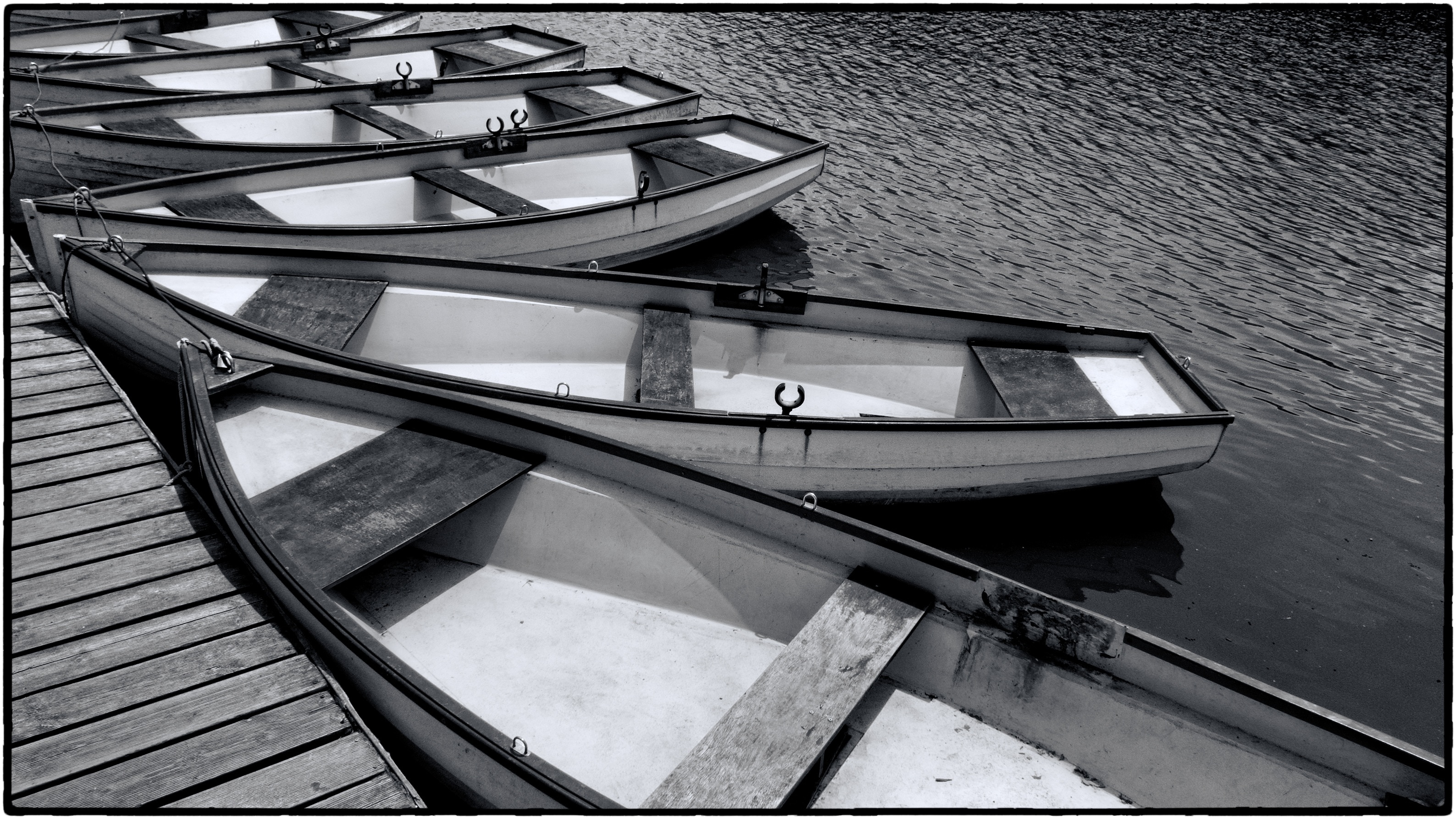 gray scale photo of rowboats