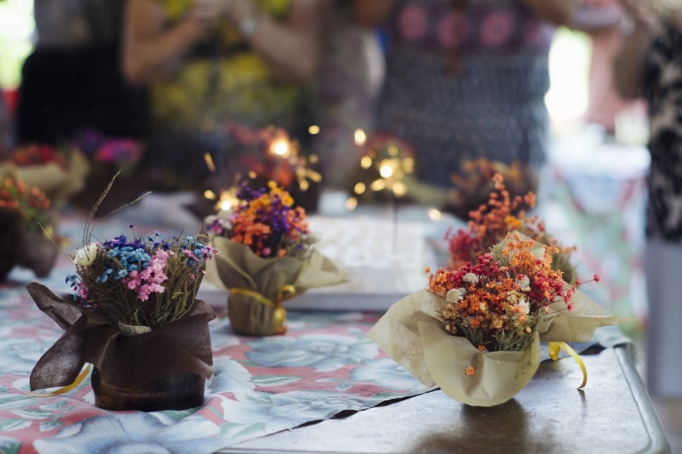 selective focus photography of 3 assorted flower table centerpieces preview