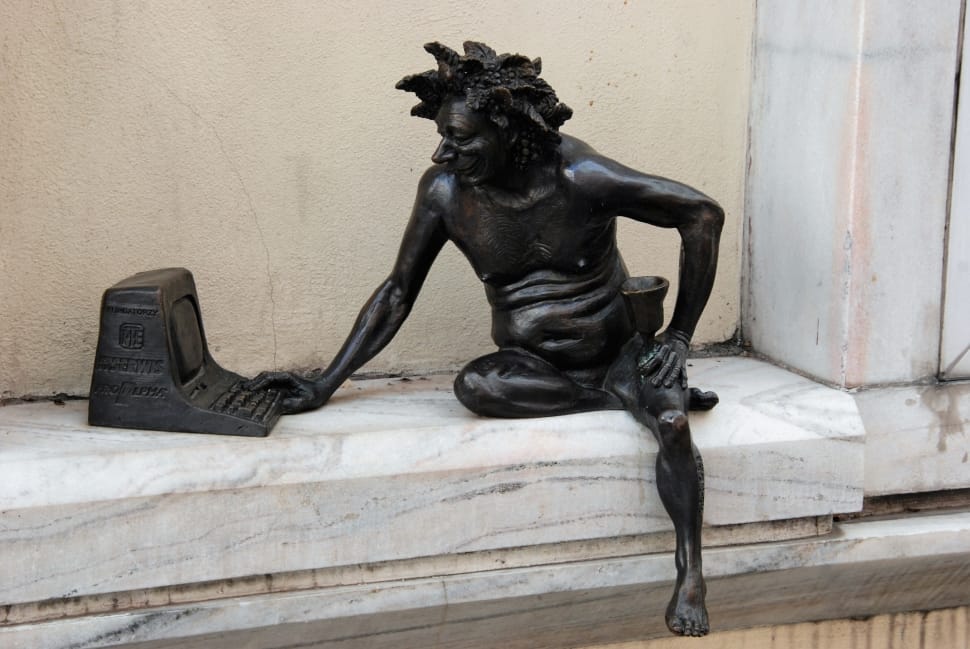 man in front of computer statue preview