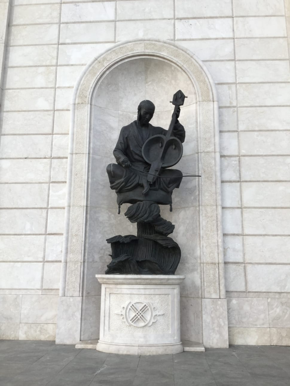 man using string instrument concrete statue preview