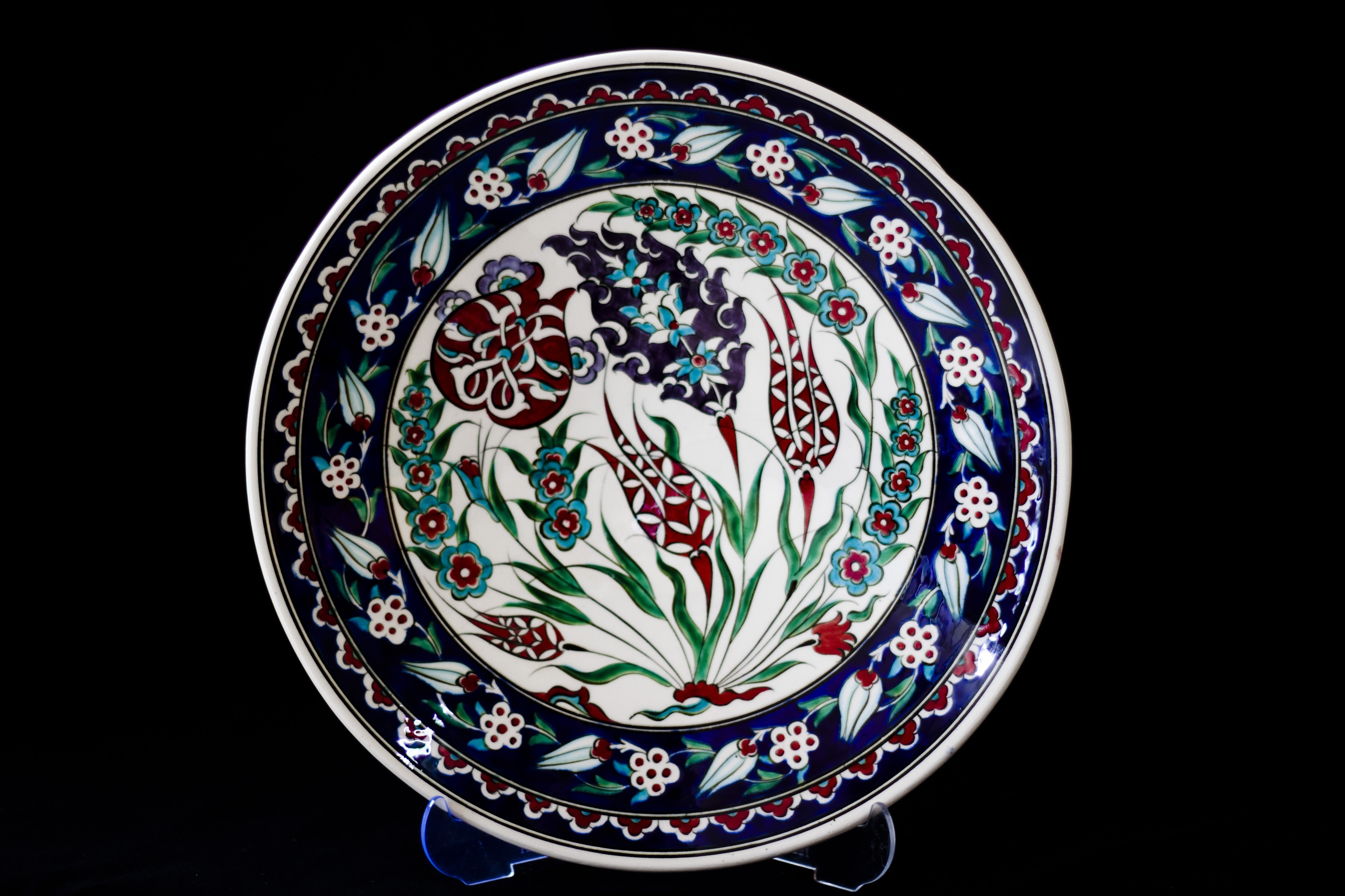 blue green and black ceramic round plate