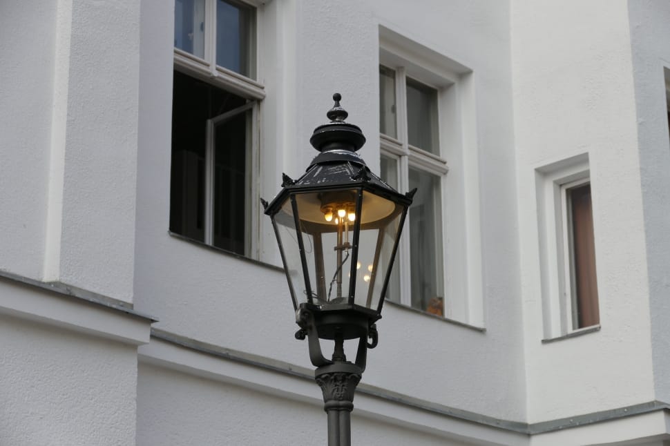 black lamp post lighted during day time preview