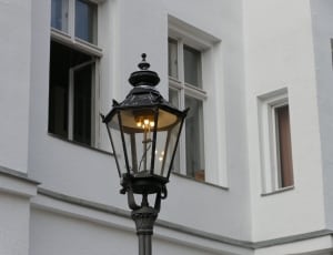 black lamp post lighted during day time thumbnail