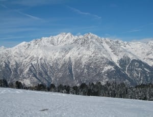 mountain covered with snow during day time thumbnail