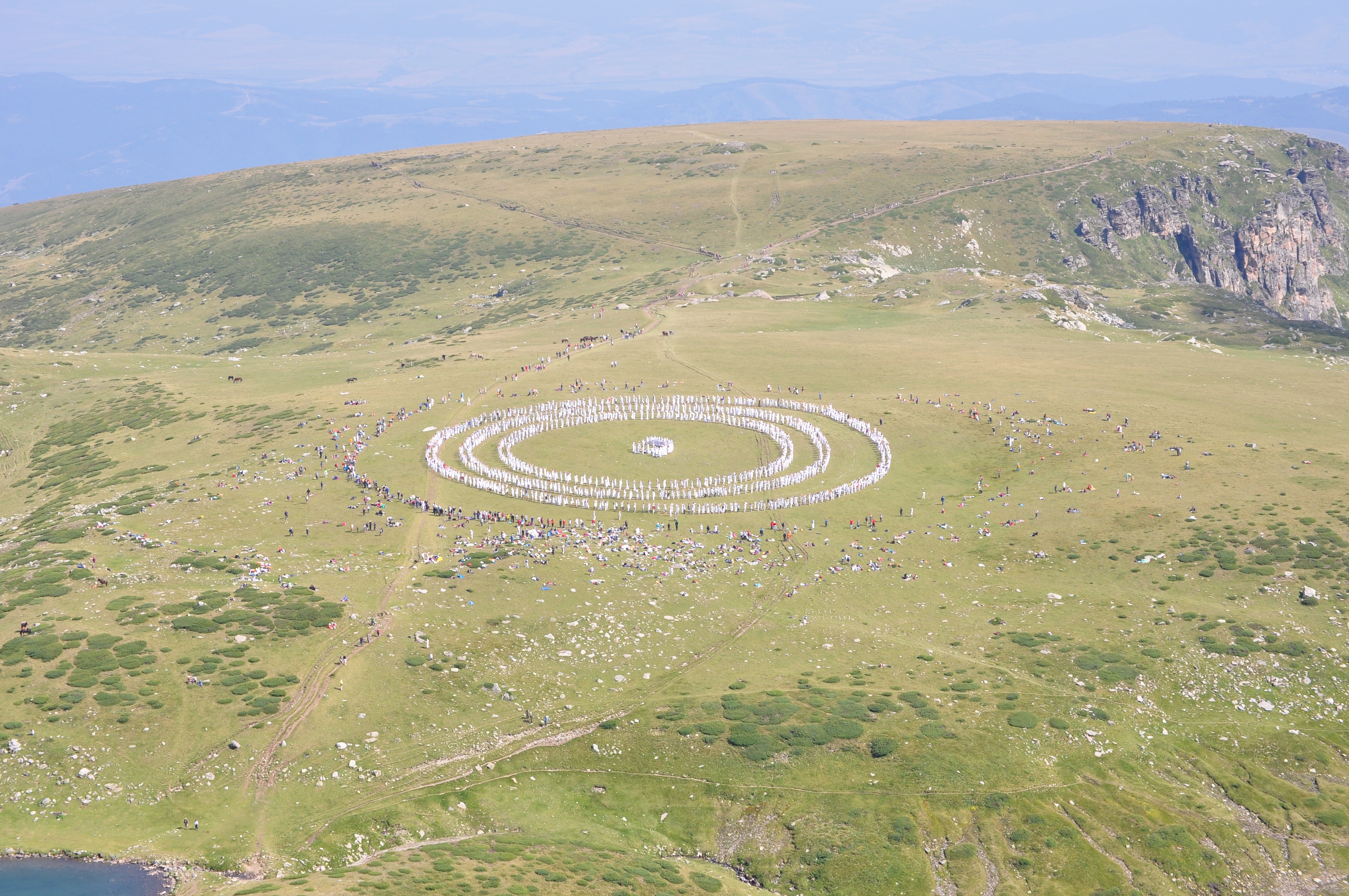 people formed circle on the mountain
