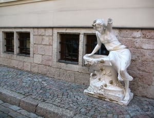 woman leaning on bird bath statue thumbnail