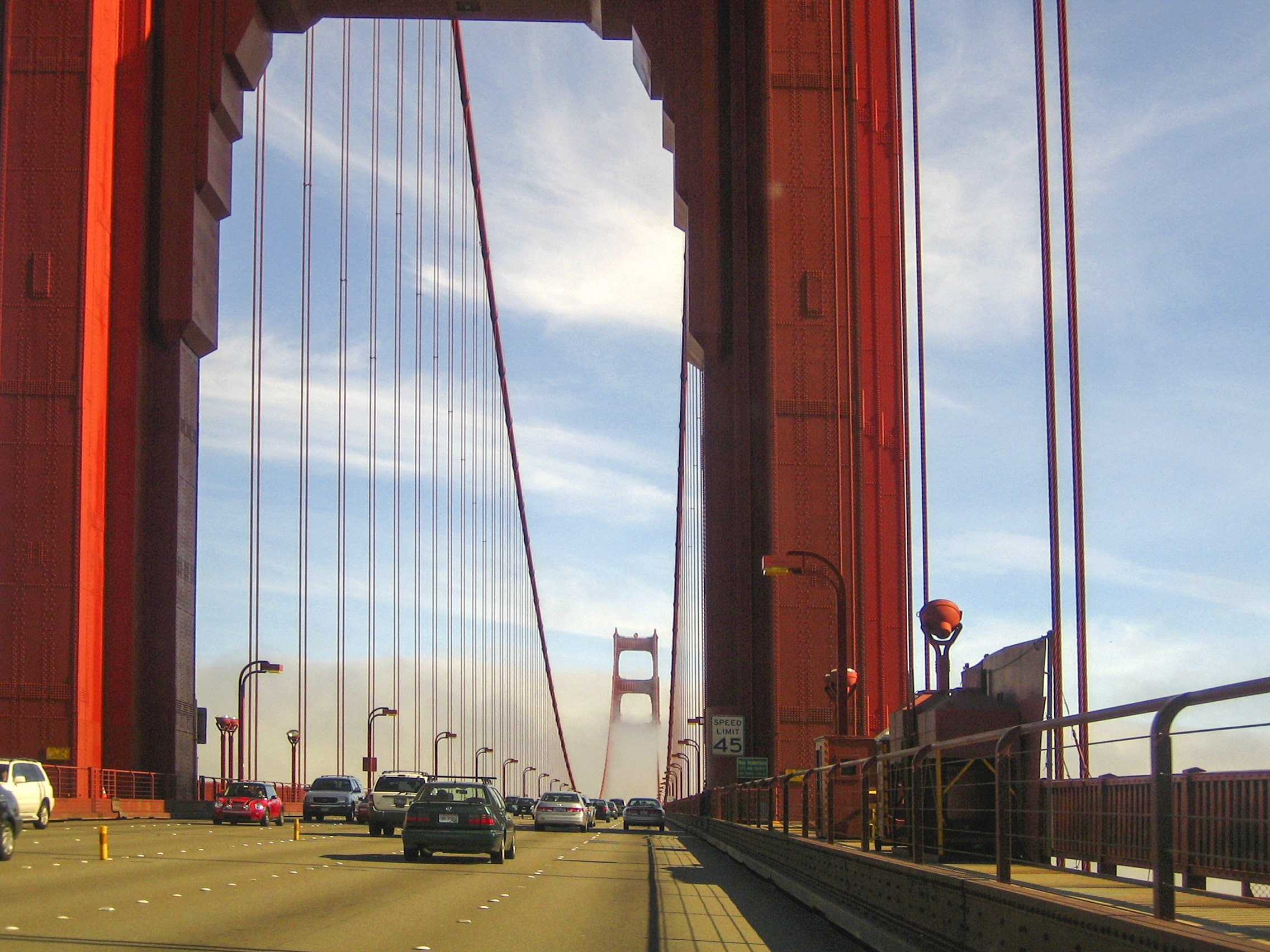 vehicles crossing through golden gate bridge during daytime