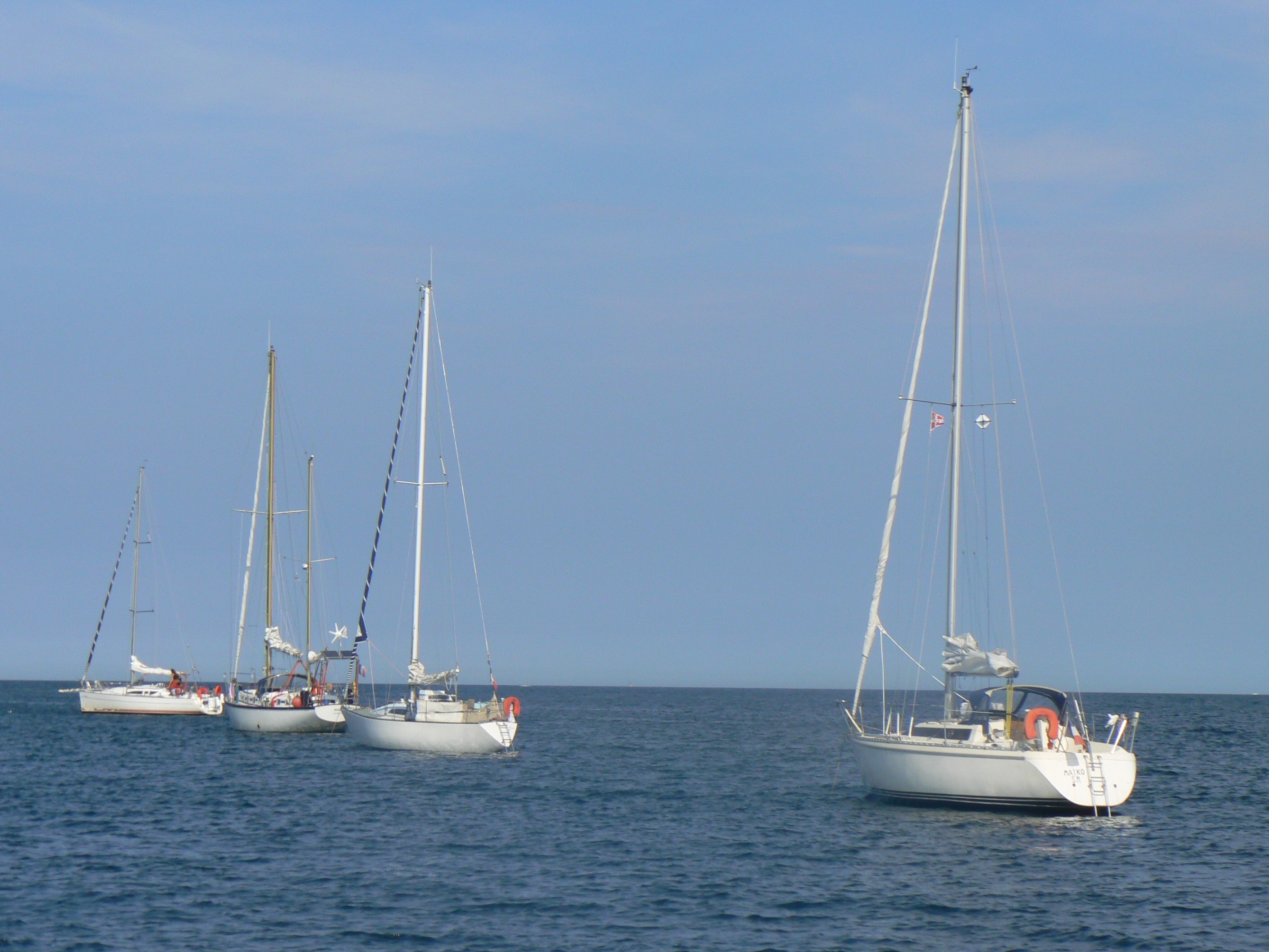 4 white boat on blue sea