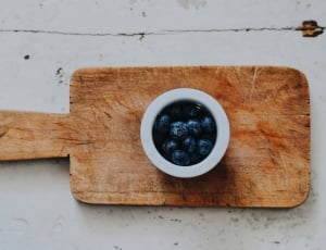 black berry serve on cup on wooden chopping board thumbnail