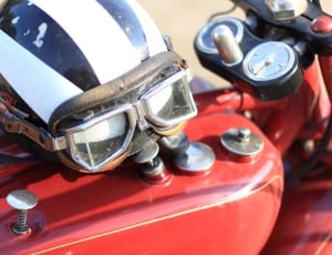 red motorcycle white black and white helmet and goggles thumbnail