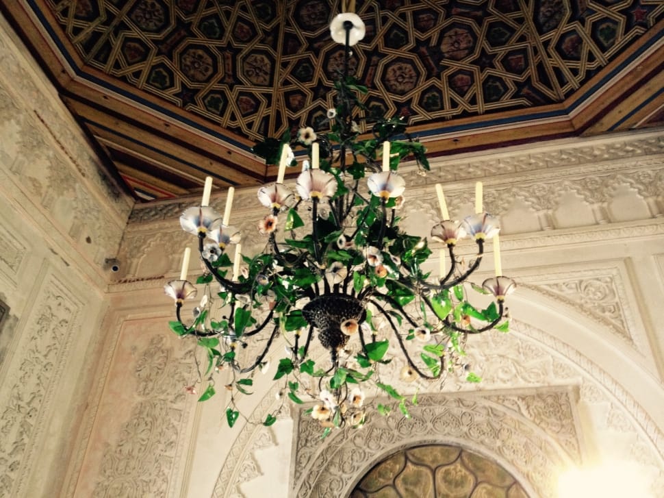 green and white candelabra chandelier with green plant preview