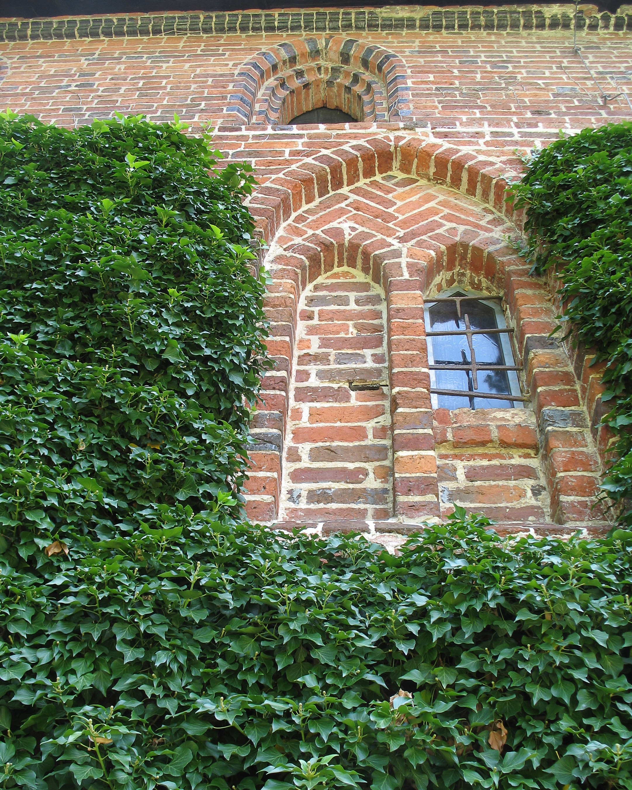 brown bricks wall with arch window