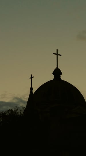 silhouette photo of a church during sunset thumbnail