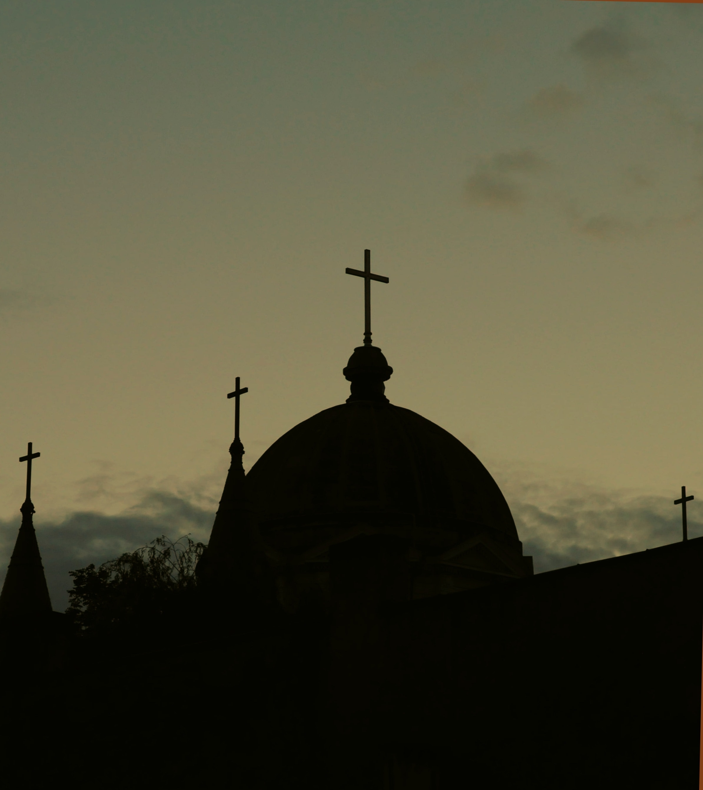 silhouette photo of a church during sunset
