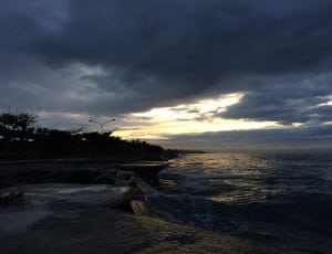 seaside cliff under cloudy sky photograph thumbnail