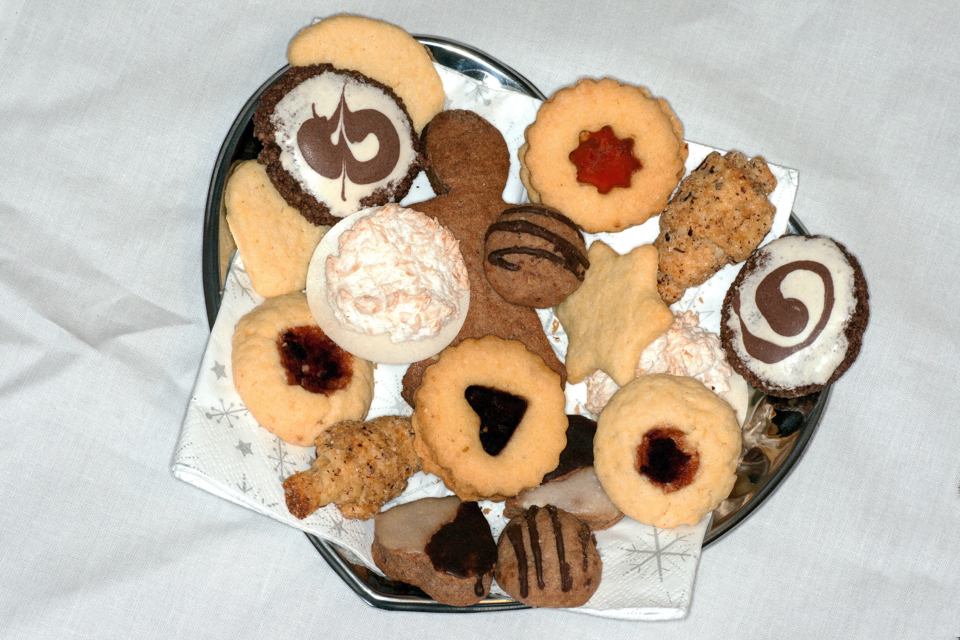 assorted cookies on top of gray steel heart shape container