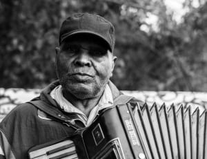 grayscale photography of a man playing accordion thumbnail