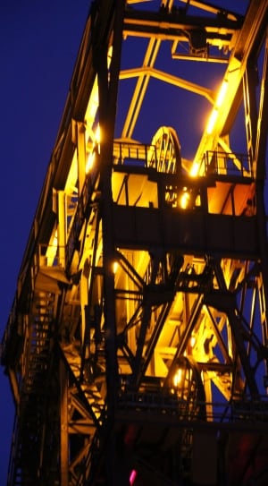 yellow and brown machinery under blue sky during nighttime thumbnail