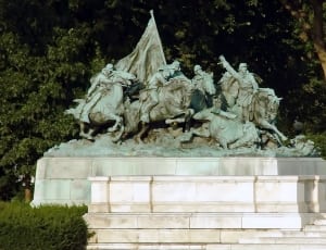 group of people ride on horses concrete statue thumbnail