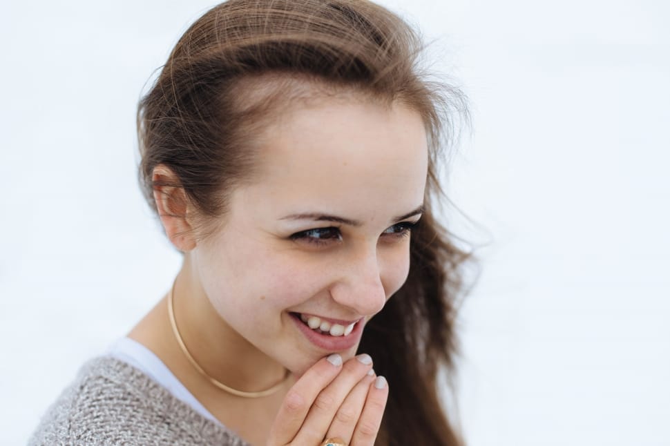woman holding her chin and smiling preview