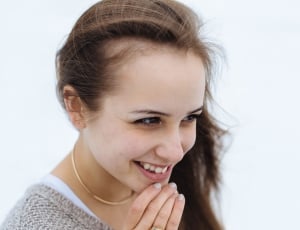 woman holding her chin and smiling thumbnail