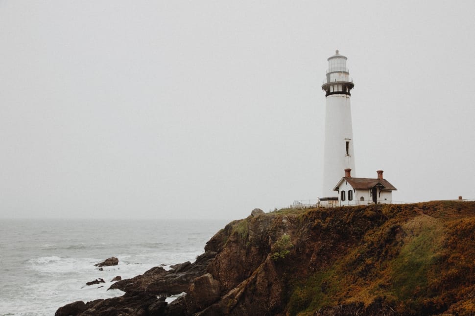 white lighthouse near sea shore preview