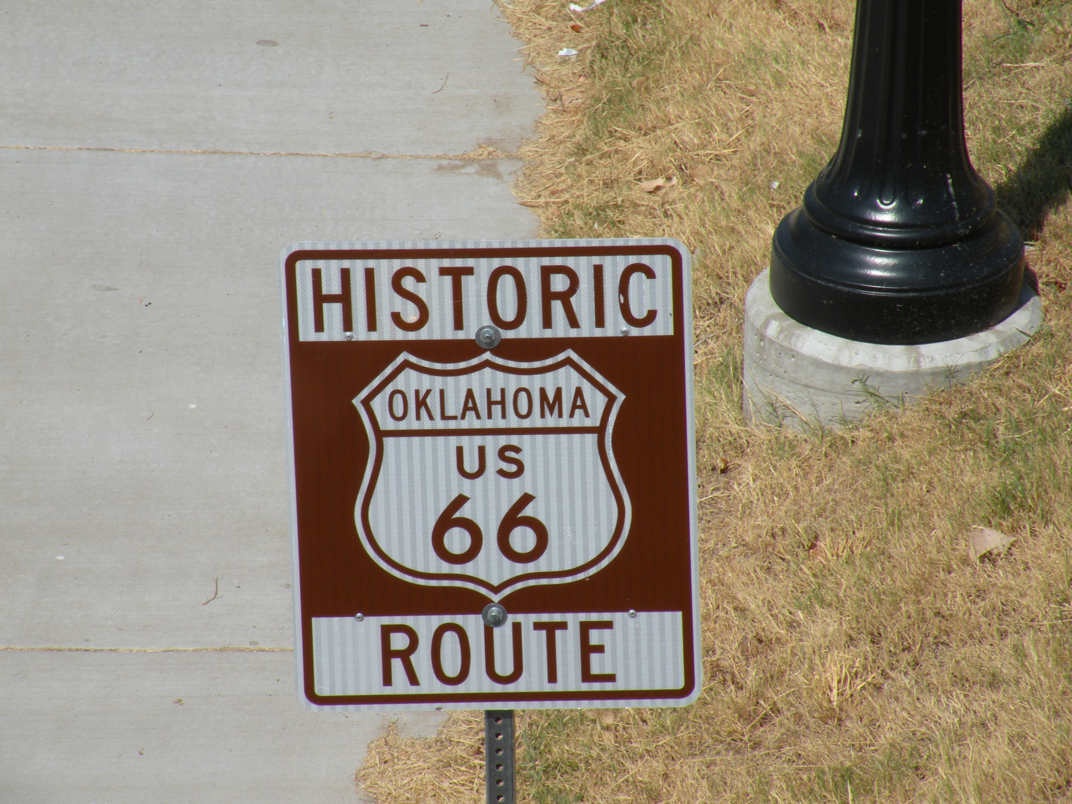 red and white oklahome us 66 historic route road sign