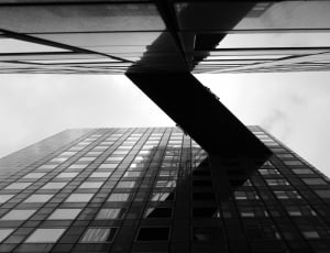 grayscale low angle photography of high rise building thumbnail