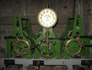 green and brass analog clock thumbnail
