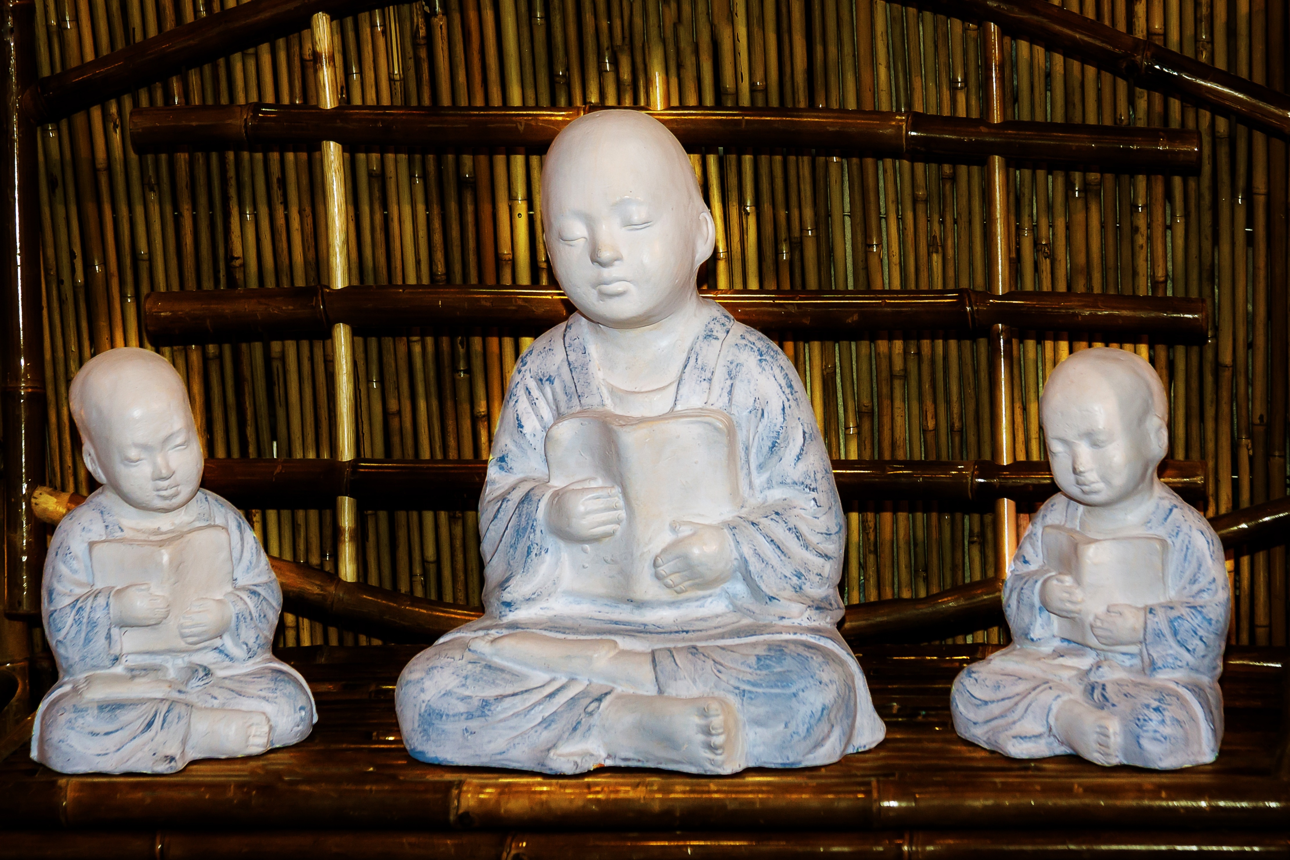 3 hairless human ceramic figurines