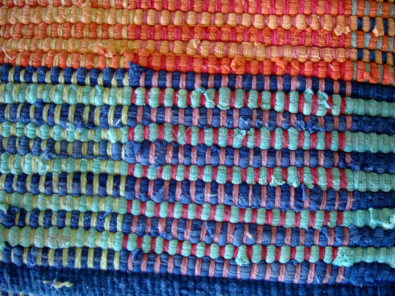 teal, blue and orange knitted textile