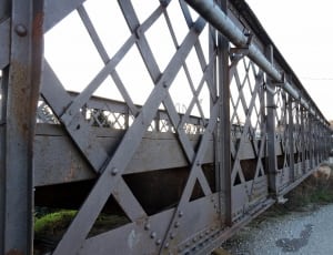 gray metal bridge through mountain thumbnail