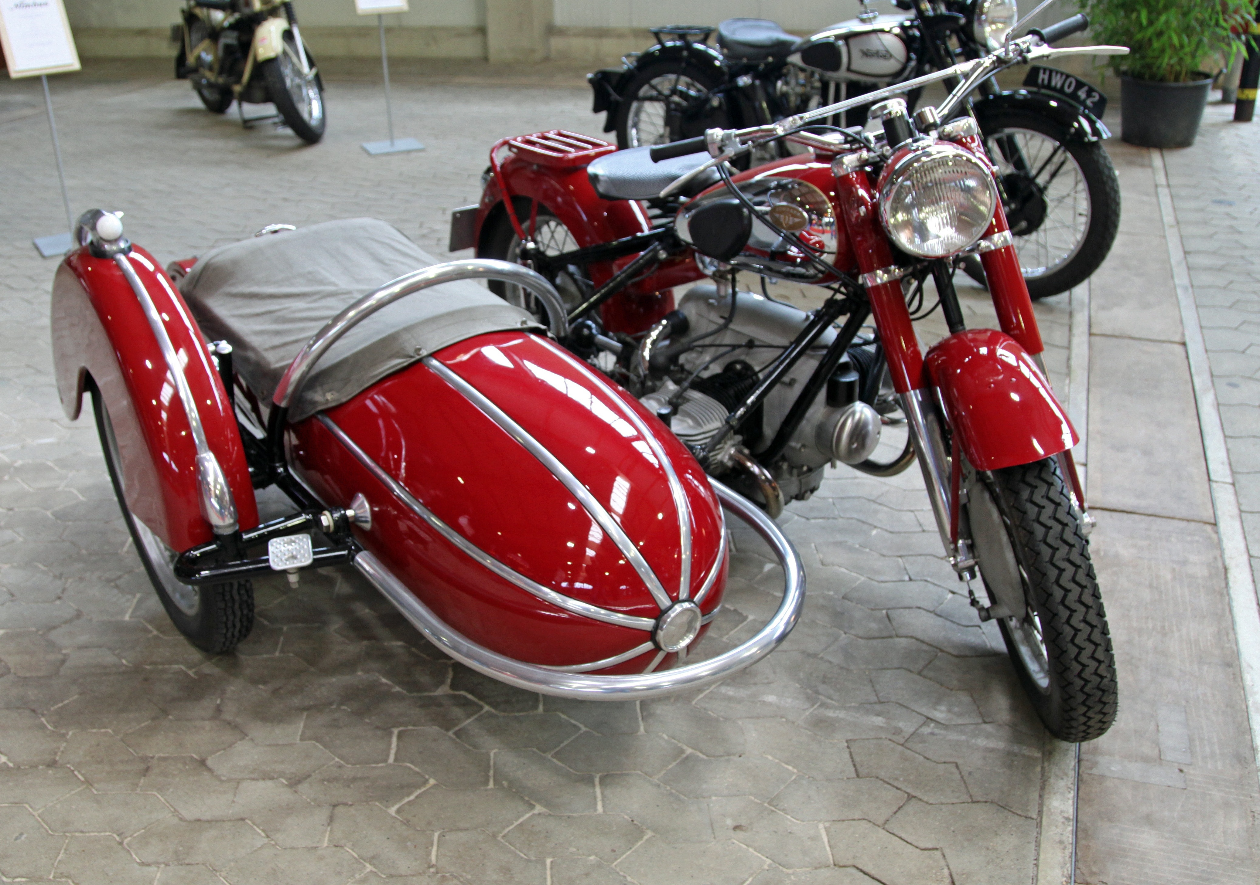 red standard motorcycle with sidecar