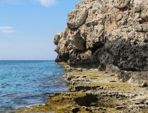 brown rocking cliff near ocean thumbnail