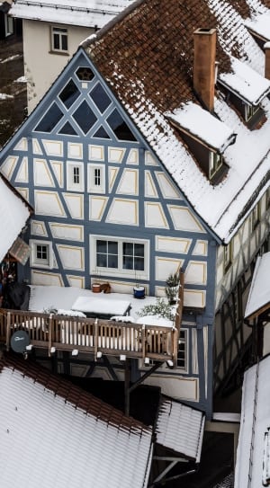 white and grey wooden house covered with snow thumbnail