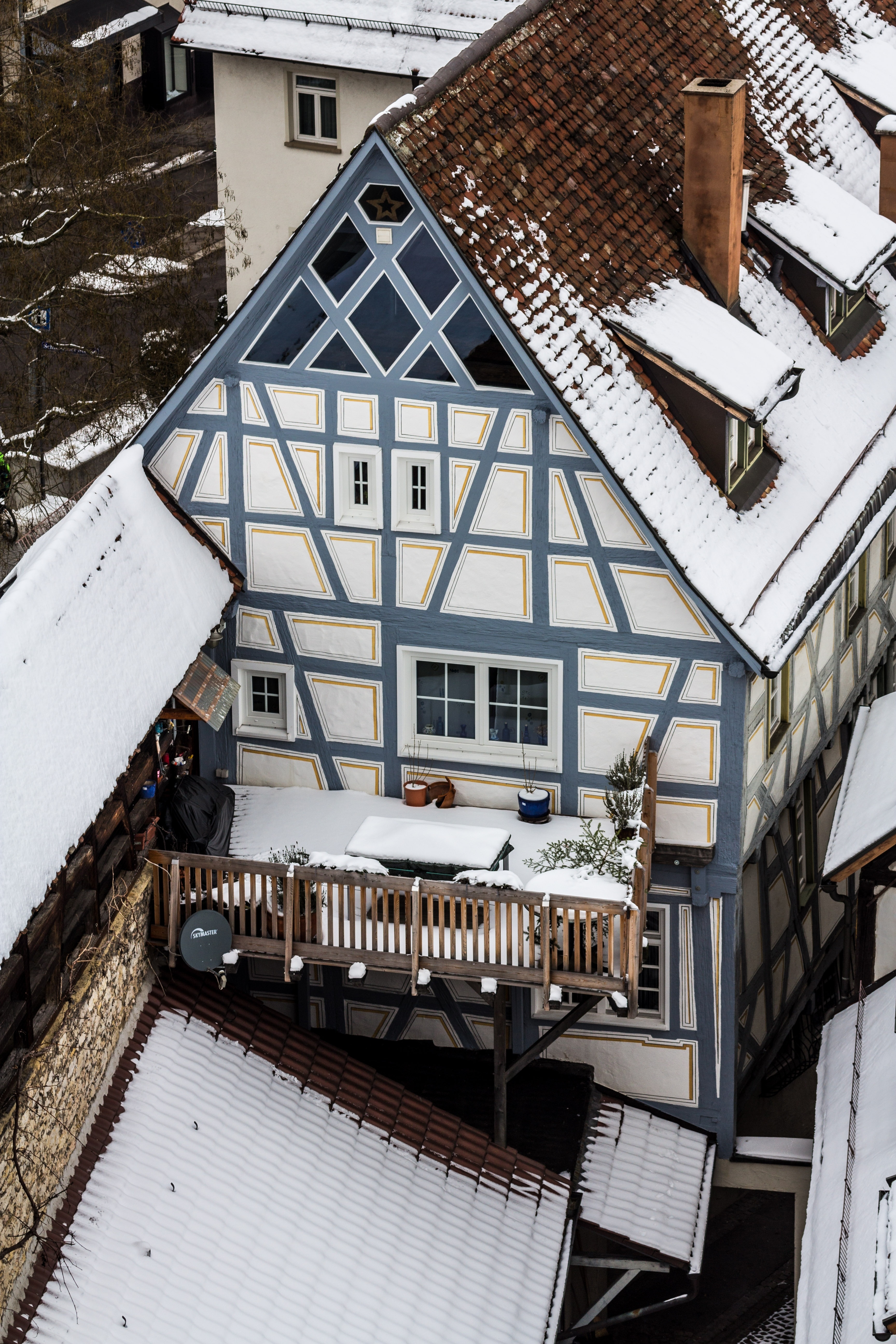 white and grey wooden house covered with snow