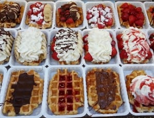 assorted pastries in white disposable containers thumbnail