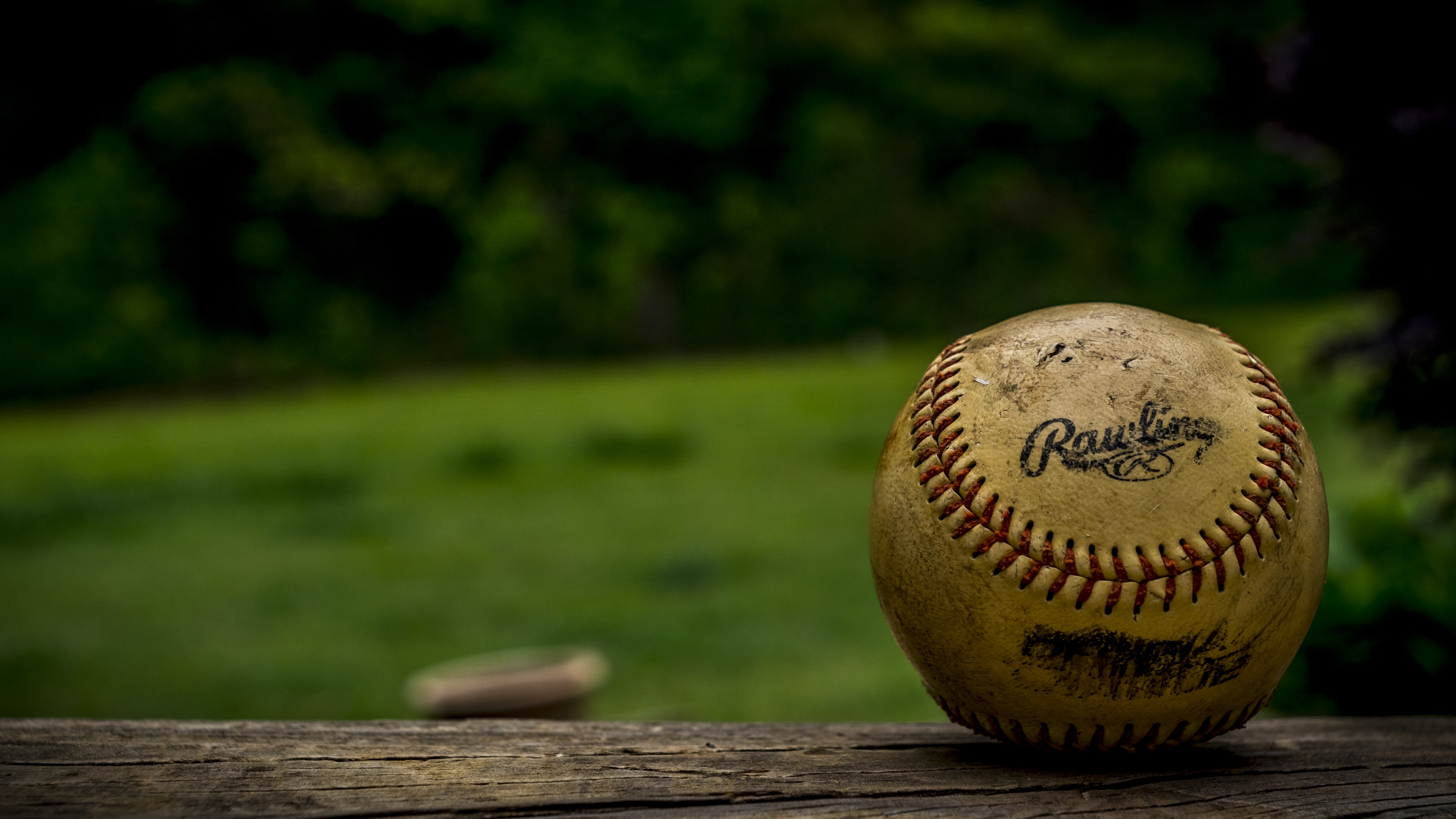 close up photo of a white rawling baseball