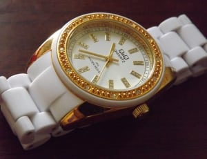 white strap and gold round analog watch thumbnail