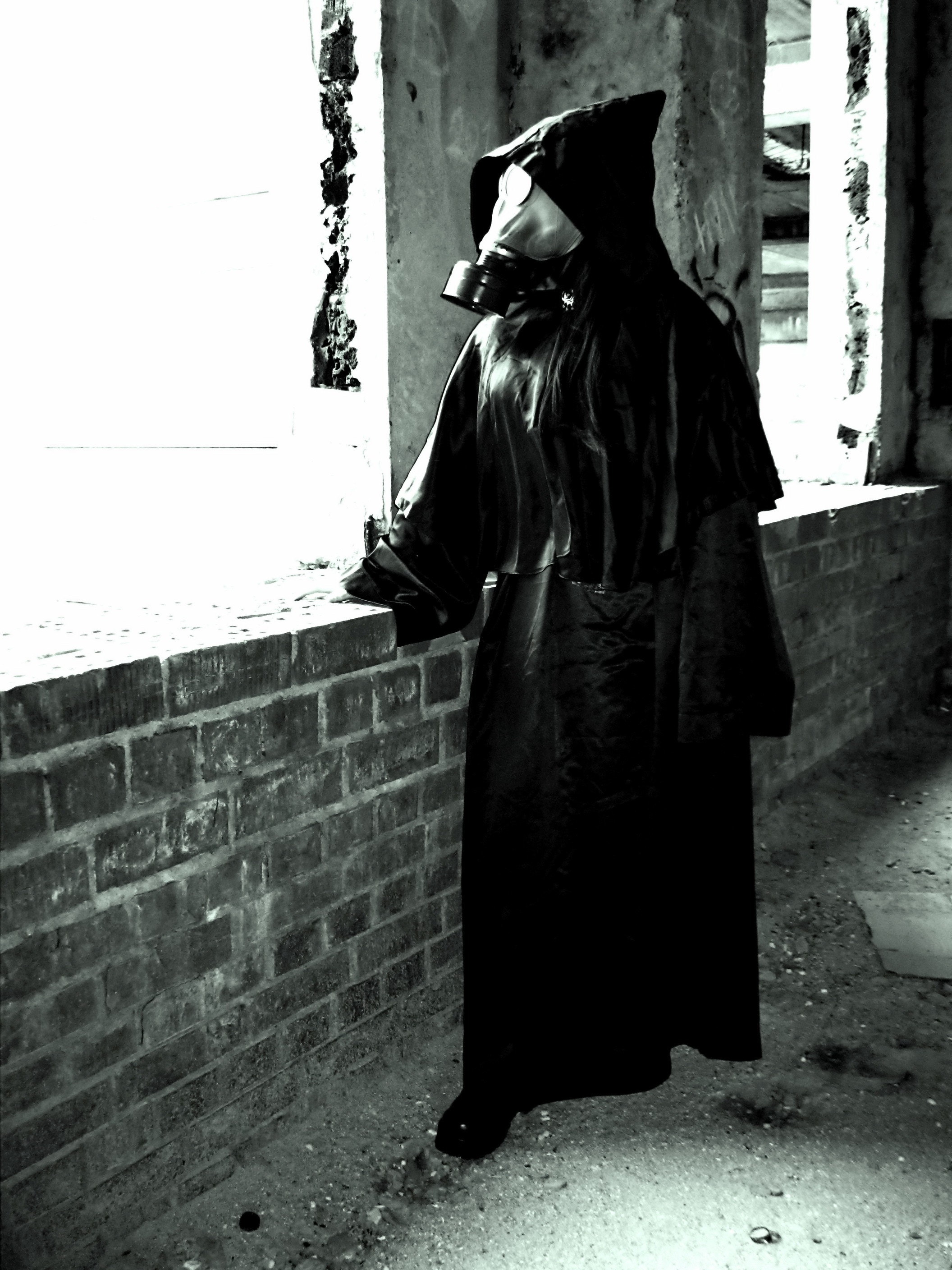 black coat with hoodie and gas mask