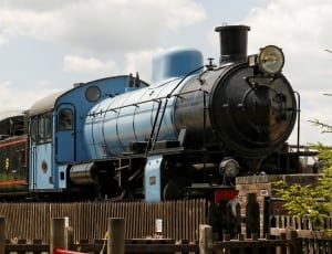 close up photo of blue and black parked train thumbnail