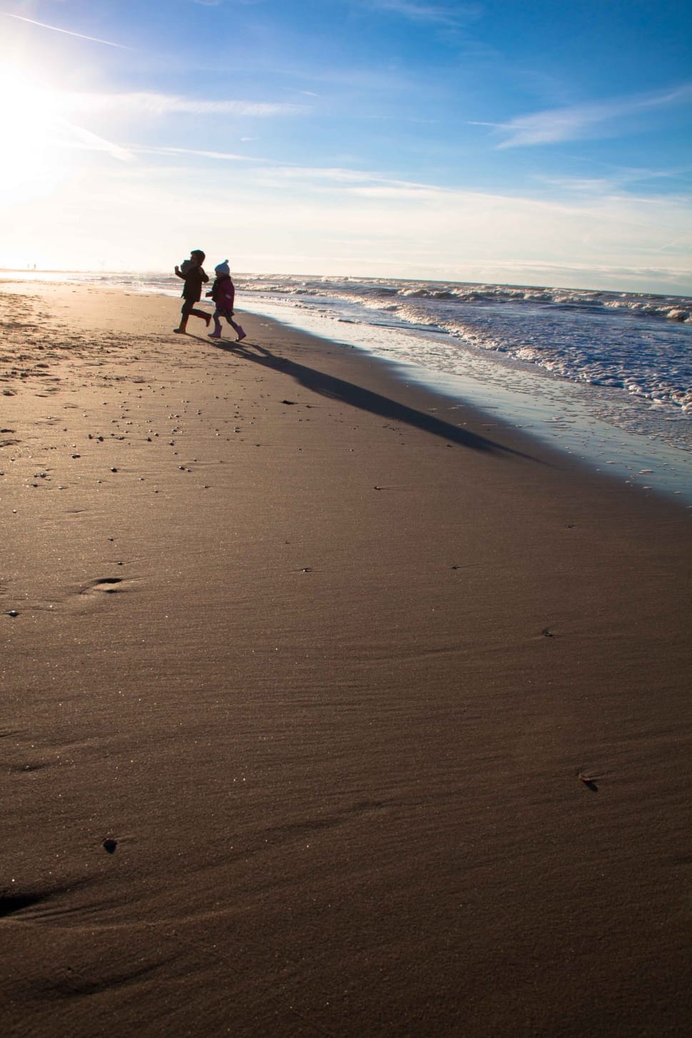 children running on beach shore during daytime preview